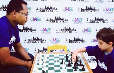 Coach giving an in-home chess lesson to a student