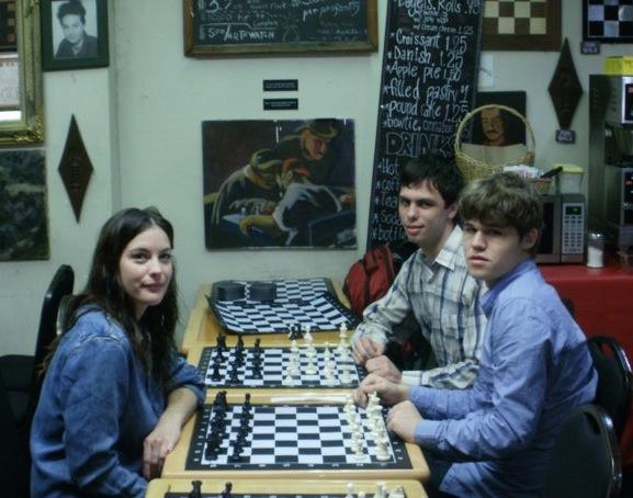 Adult students taking a chess lesson at the club